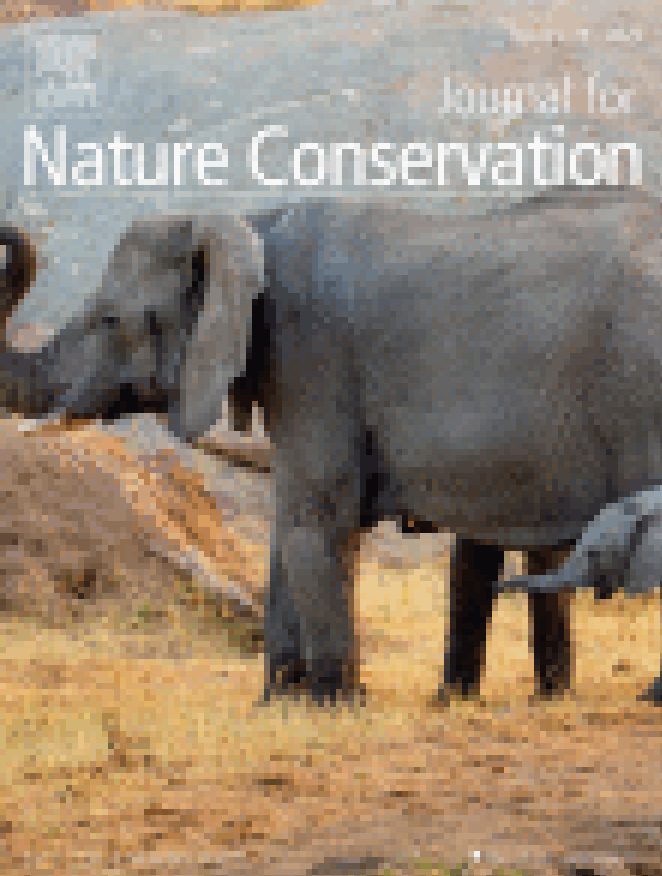 Journal for Nature Conservation journal cover featuring the image of an elephant in tall yellow grass